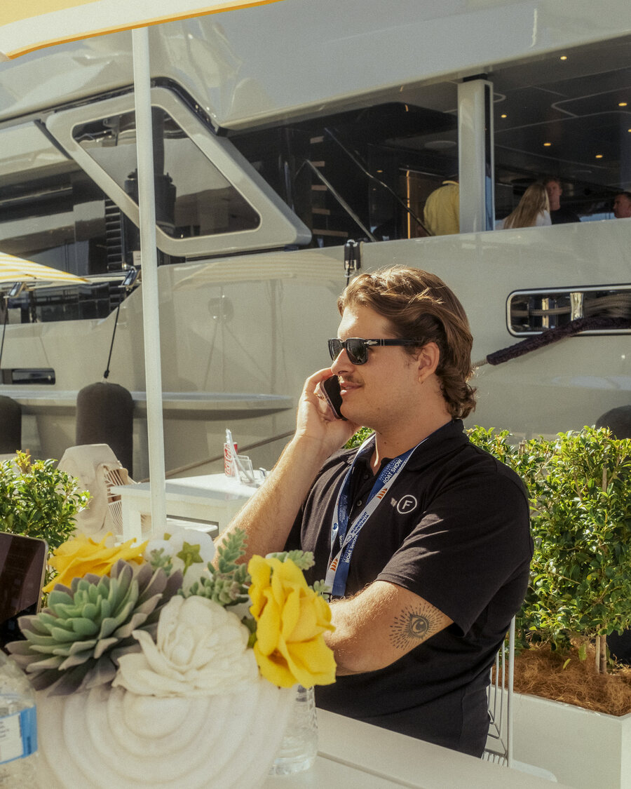 Franky, founder of Frames Media, on the phone at a boat show